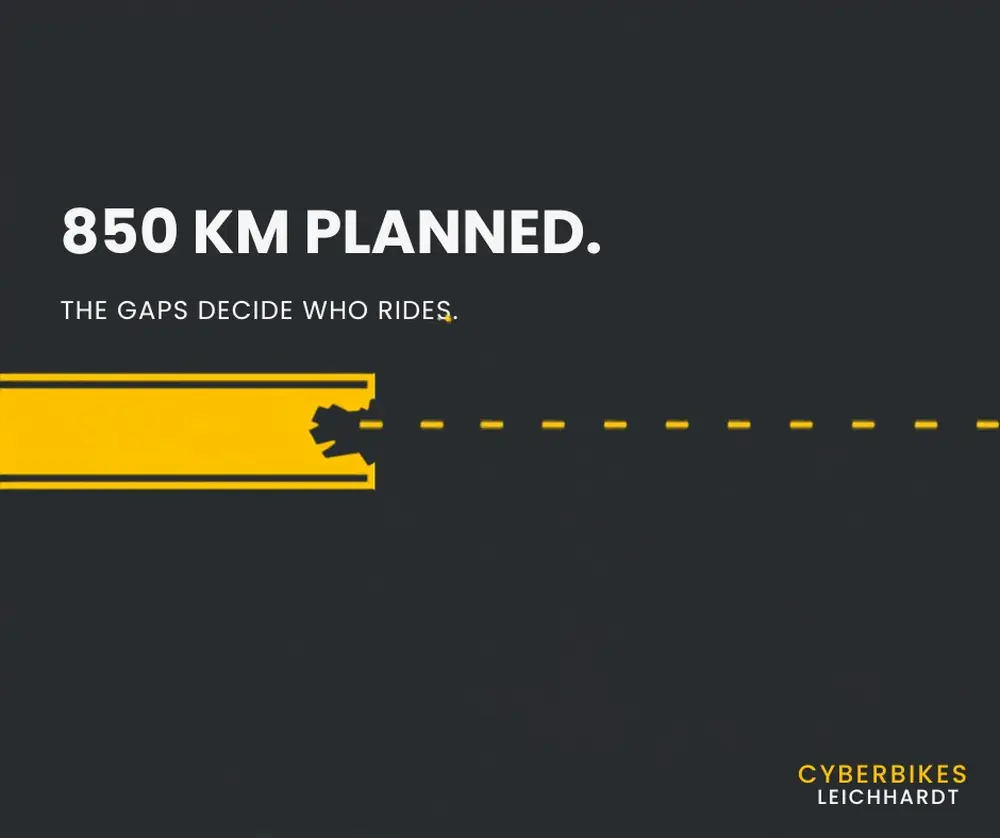 Cyber Yellow bike lane stripe on a charcoal background breaking off into a dashed gap, illustrating how Sydney bike lanes just stop