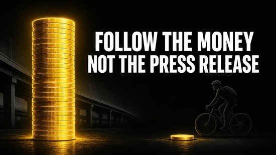 Tall stack of gold coins for motorways beside a single coin for cycling, showing how the Sydney transport budget is allocated